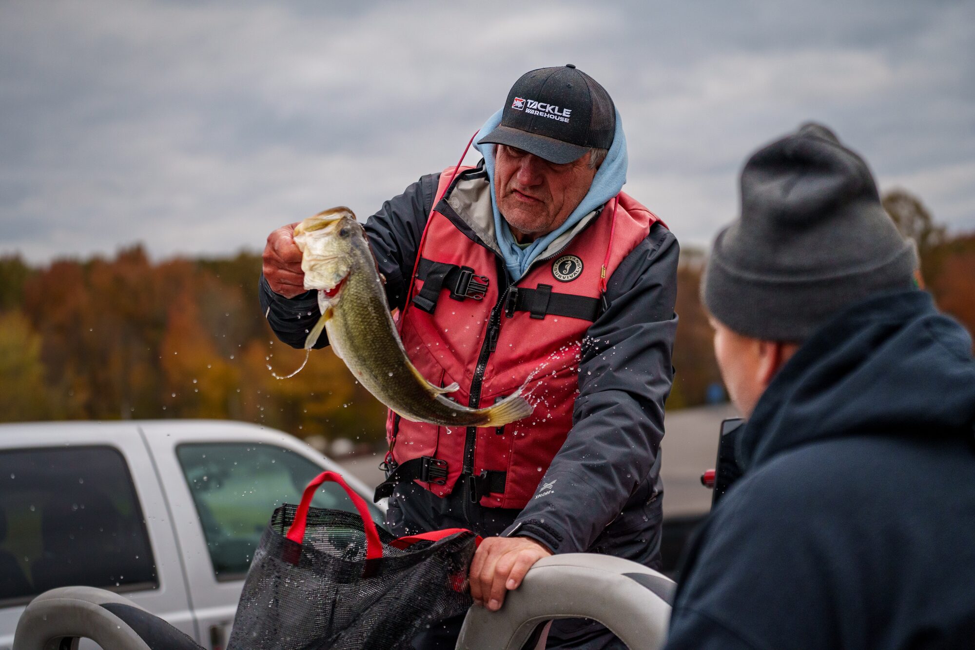 Angler holding a bass at a USA Bassin event