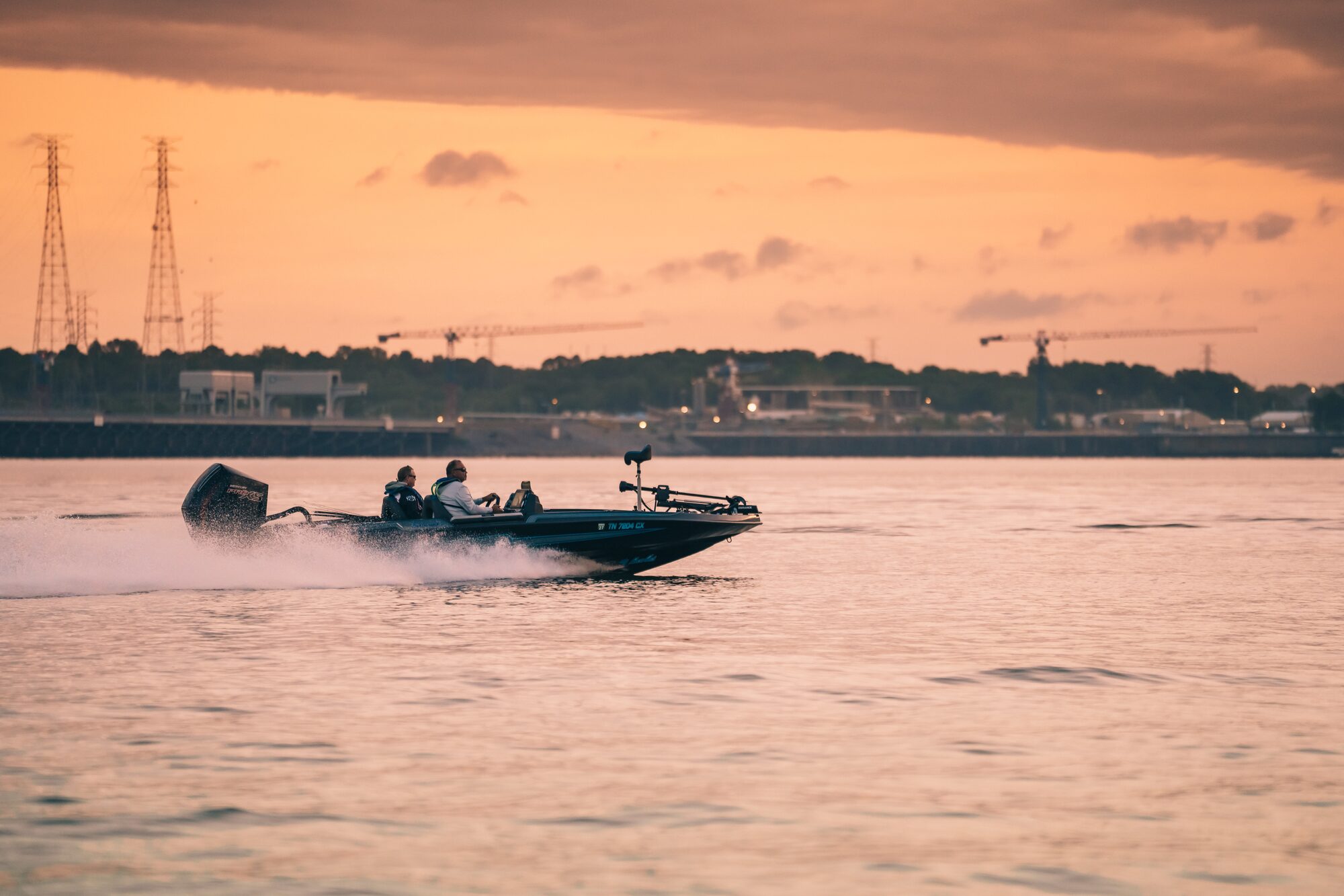 USA BASSIN boat running across the water at sunrise