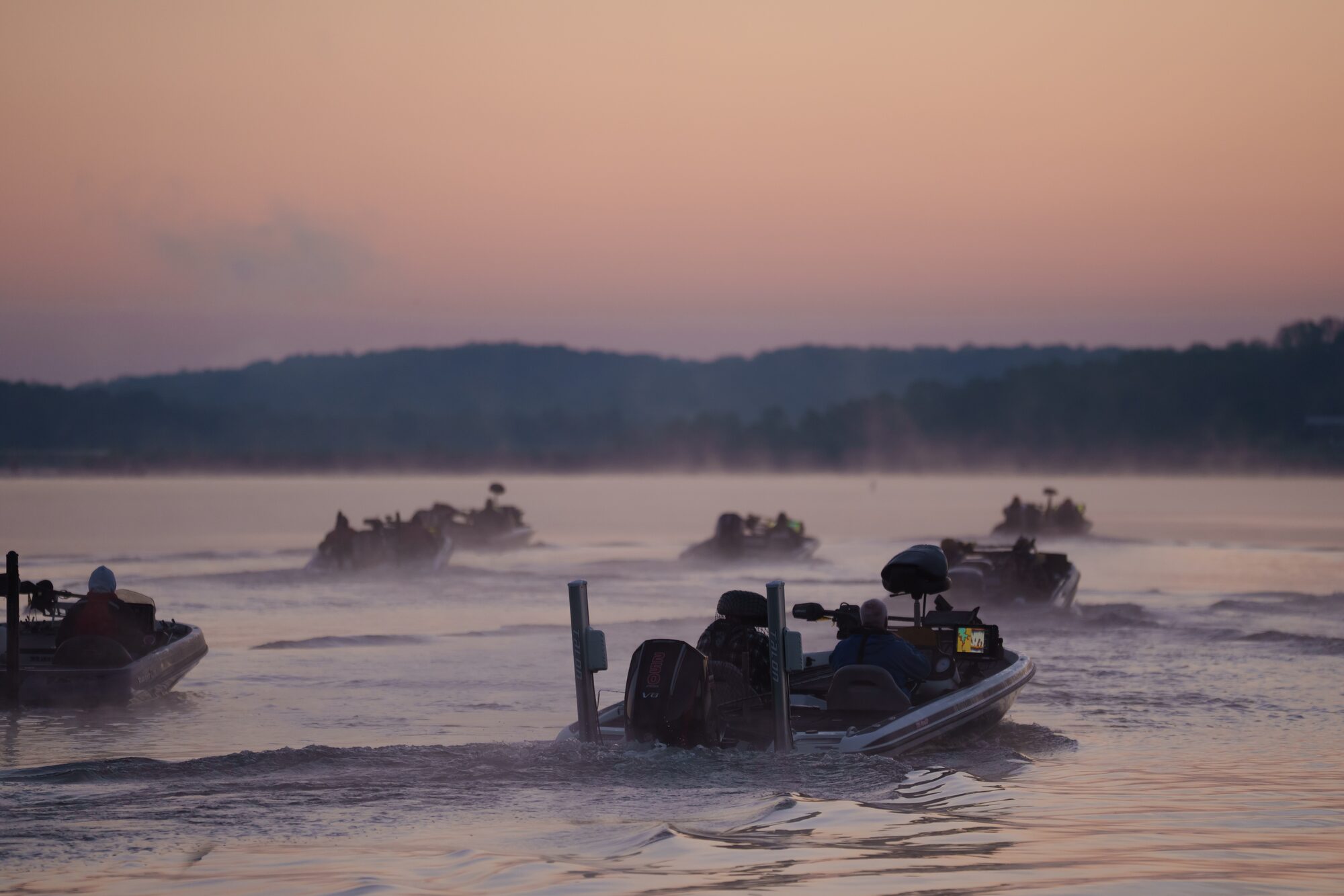 Tournament boats idling out at sunrise